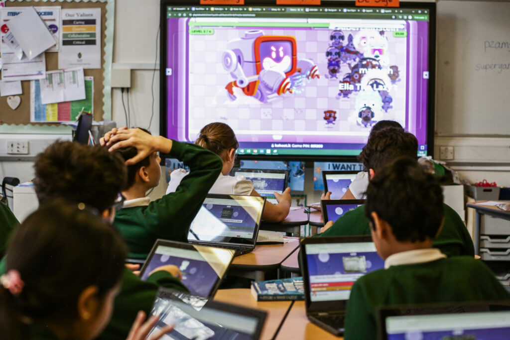 Students playing robot run in classroom